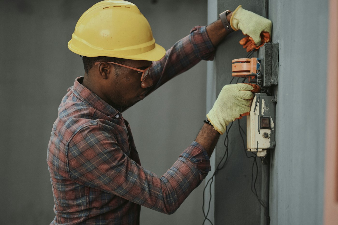 Electrician working carefully inside an electrical panel